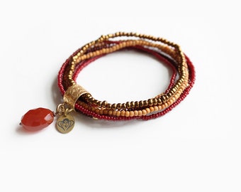 Handmade layered bracelet made with sandalwood beads, seed beads and a carnelian stone