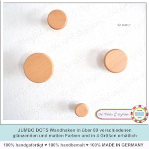 Könnte beinhalten: Vier Wandhaken aus Holz in verschiedenen Größen, alle in naturbelassenem Holz. Die Haken sind rund und haben eine glatte Oberfläche. Der Text "#o natur" ist in der oberen rechten Ecke des Bildes sichtbar.