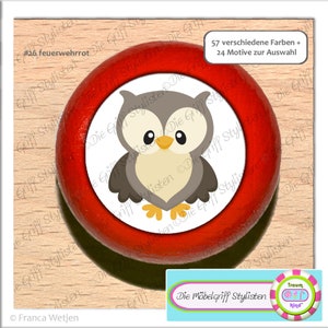 May include: Red wooden knob with a white sticker featuring a cartoon owl with gray feathers, yellow feet, and black eyes. The sticker text reads "Die Möbelgriff Stylisten".