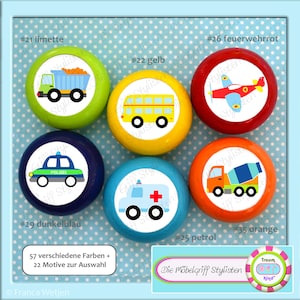May include: Six colorful wooden knobs with different vehicle designs. The knobs are labeled with numbers and names in German. The knobs are arranged in a circle on a blue background with white polka dots. The text "Die Möbelgriff Stylisten" is visible at the bottom of the image.