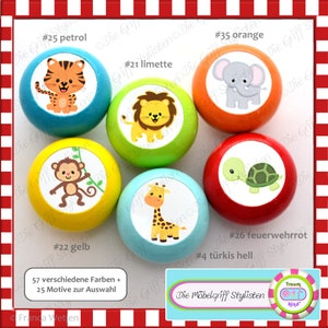 May include: Six wooden knobs with different animal illustrations. The knobs are painted in various colours, including yellow, blue, green, red, and orange. The animals include a tiger, lion, monkey, giraffe, turtle, and elephant. The text "57 verschiedene Farben + 25 Motive zur Auswahl" is printed below the knobs.