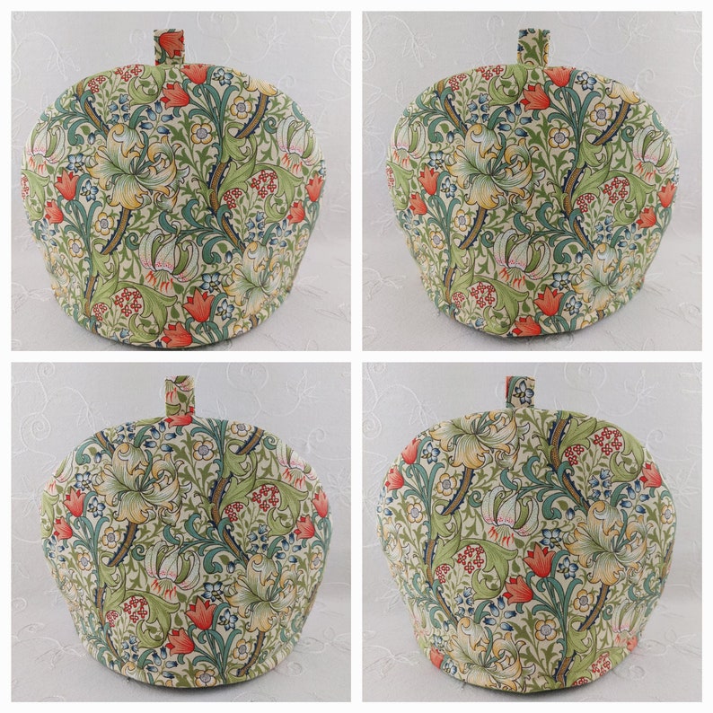 K&ouml;nnte beinhalten: Ein gr&uuml;ner, roter und wei&szlig;er Teekoscher mit einem Blumenmuster. Der Koscher ist kuppelf&ouml;rmig und hat einen Griff oben.