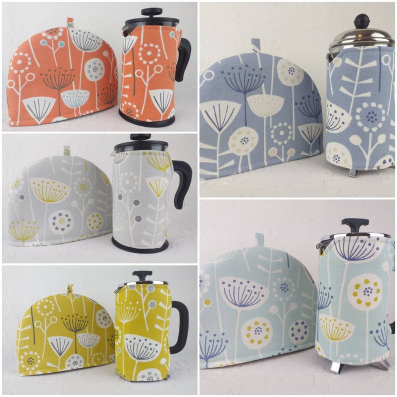 May include: Set of four French press coffee pot covers in various floral patterns. The covers are made of fabric and feature a geometric design with a light blue, orange, yellow, and grey colour scheme.