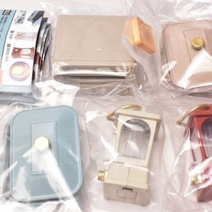 May include: A set of miniature furniture pieces, including a light blue dresser, a beige table, a beige lamp, a white lamp, and a red lamp. The furniture is packaged in clear plastic bags.