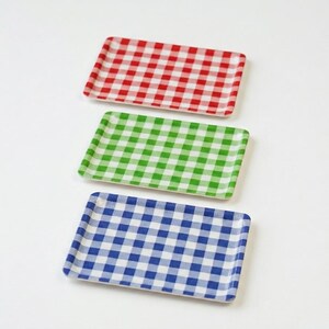 May include: Three rectangular trays arranged vertically, each featuring a distinct gingham check pattern. The top tray is red and white, the middle tray is green and white, and the bottom tray is blue and white. Each tray has a smooth surface.
