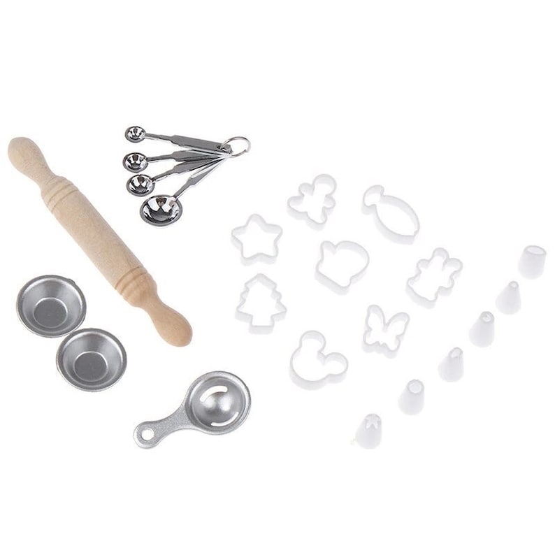 May include: A baking set with a wooden rolling pin, measuring spoons, small metal bowls, and various cookie cutters in shapes like stars, trees, and a butterfly. Also included are several icing tips.