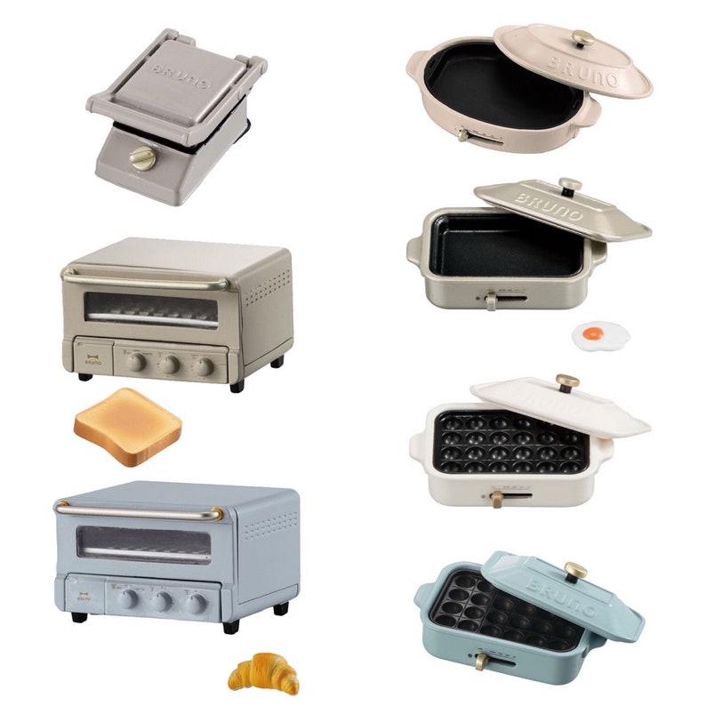 May include: A collection of miniature kitchen appliances including two toaster ovens, a sandwich press, and four multi-functional cookers with lids. The items feature the brand name BRUNO and include small food accessories like toast, a croissant, and an egg.