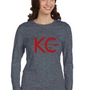 May include: A heather gray long-sleeve shirt with a red graphic of the letters "KC" with an arrow through the "C".
