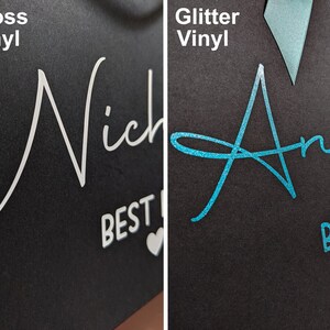 Close-up of two black gift bags, one with Gloss Vinyl and one with Glitter vinyl to show the difference in finish. The Gloss vinyl reflects the light, and the Glitter vinyl sparkles.