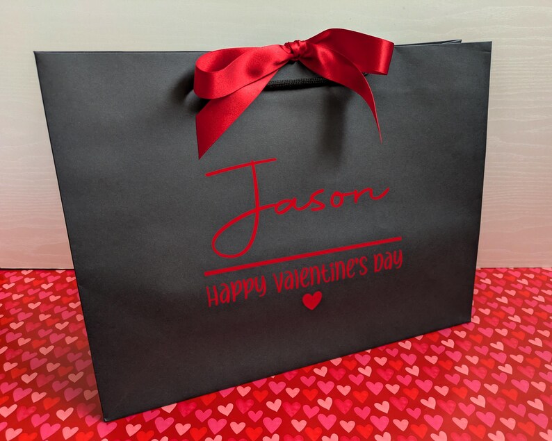 Black Valentine's gift bag with the name "Jason" in large text, with "Happy Valentine's Day" below in smaller text.