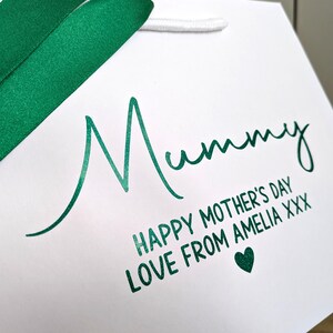 White gift bag with green Glitter text. Mummy is in a large cursive font, and below in smaller text reads "Happy Mother's Day" and a personalised message.