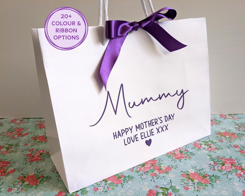 White gift bag for Mother's Day. The bag shown has purple text and a purple ribbon, with Mummy in large text, and a personalised message below.
