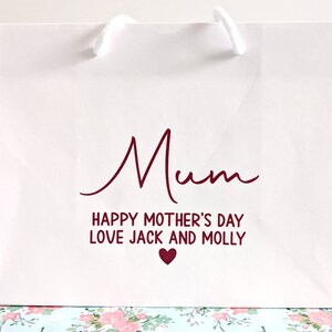 White gift bag with pink text "Mum Happy Mother's Day Love Jack and Molly"