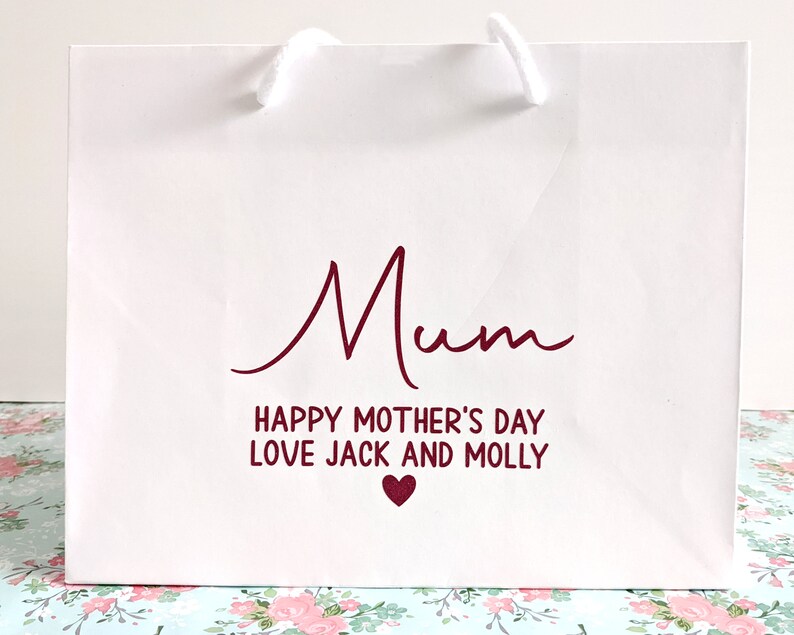 White gift bag with pink text "Mum Happy Mother's Day Love Jack and Molly"