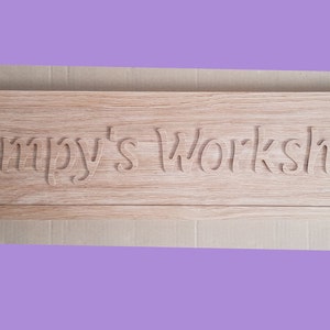 May include: A wooden sign with the text "Bumpy's Workshop" carved into it.