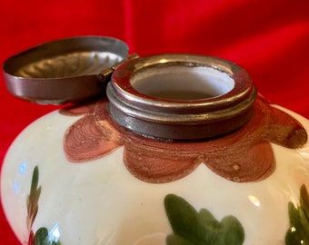 Antique porcelain ink well.  Flower shape with brass lid and bird/floral design.