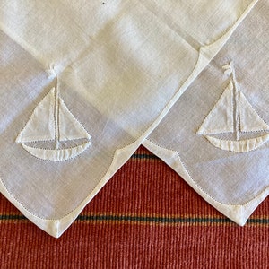 7 antique/vintage handkerchiefs including 3 wedding, 2 white on white appliqué, a fine lawn and a handkerchief envelope with fine embroidery