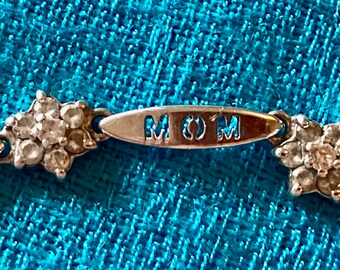 Mother's Day Gift!  Pretty sterling silver with CZ stones bracelet.  "Mom" and hearts.  Very subtle but with sentiment.