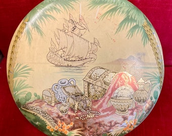 Gorgeous round tin with no labels or name markings.  Very nice condition.  8 inches round X 3.25 inches tall.  Ship & treasure theme.