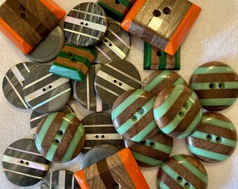 27 Mod buttons.  Must see.  circles and squares. wood and plastic, inlaid MOP.  Size 3/4 inch to 1.25 inches.  orange, green, grey, MOP