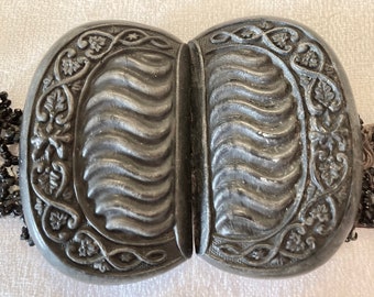 Bakelite belt buckle which is attached to a beaded belt.  1940s.  Black.  each half is 2.5 X 1.5.