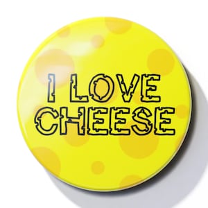 May include: A yellow round button with a cheese pattern and the text "I LOVE CHEESE" in black.