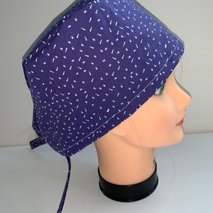 Tiny teeth on bluish/purple background scrub cap