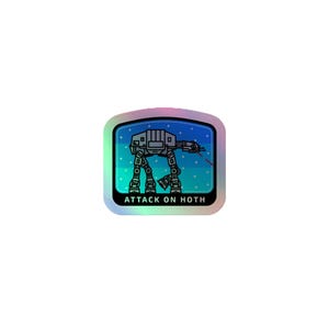 May include: A square holographic sticker with rounded corners featuring a dark gray AT-AT walker on a blue background with white dots. A thin red laser line extends from the walker. The text ATTACK ON HOTH is printed in white at the bottom.