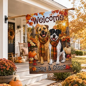 May include: A rectangular garden flag featuring a fall scene with two dogs wearing plaid scarves. The text reads Welcome at the top and Zoey & Cisco at the bottom. The background shows a wooden fence, pumpkins, and autumn leaves in shades of orange, yellow, and brown.