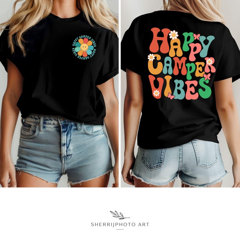 May include: Black t-shirt with a retro-style graphic that says "Happy Camper Vibes" in colorful letters with flowers and butterflies. The back of the shirt has a smaller graphic of a flower with a smiley face.