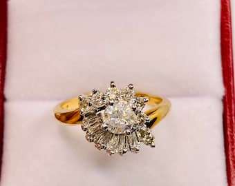 May include: A gold ring with a large round diamond surrounded by smaller diamonds in a swirl design.