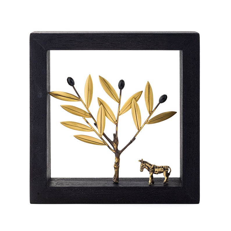 Dark grey wood frame surrounding olive tree and donkey figurines, made in gold plated brass. A small but very detailed, handmade work of art that will always remind you of the Medieterranean and your time in Greece.