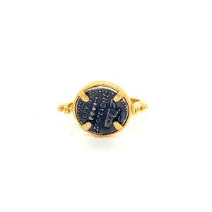 May include: A gold ring with a round, silver coin set in the center. The coin features an inscription in Greek, "ANTONINVS", and a depiction of a Roman emperor.