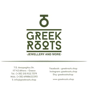 May include: Green logo with the Greek letter theta and the words "GREEK ROOTS" in all caps. Below the logo is the text "JEWELLERY AND MORE." The business card also includes the business's address, phone number, mobile number, email address, and social media handles.