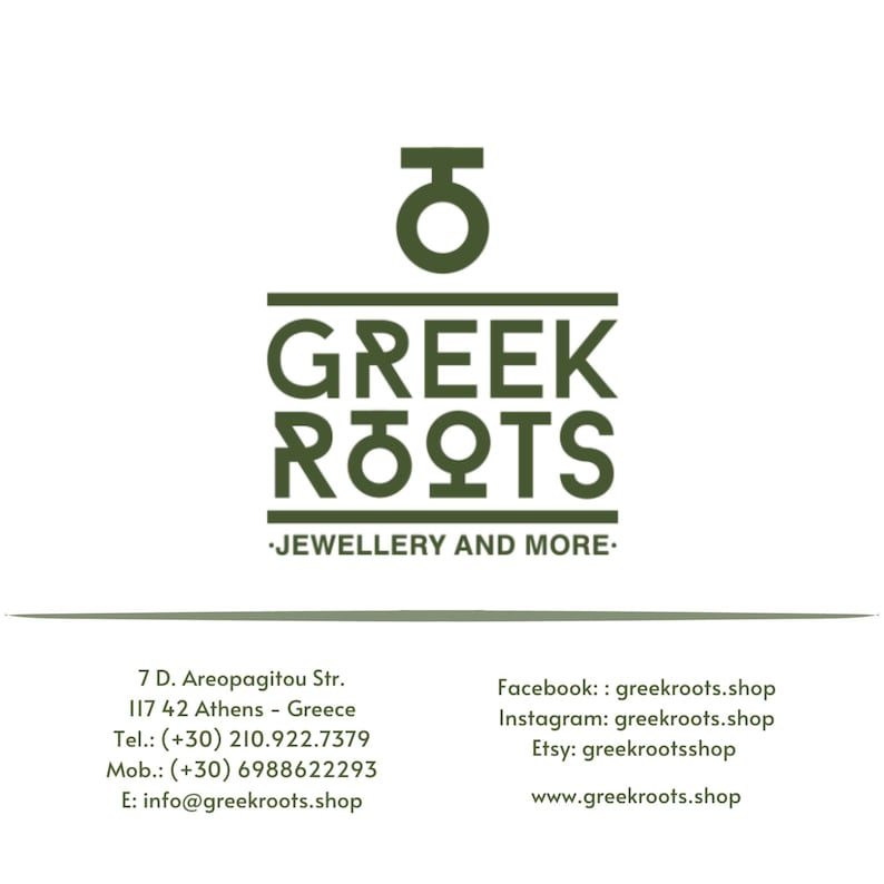 May include: Green logo with the Greek letter theta and the words "GREEK ROOTS" in all caps. Below the logo is the text "JEWELLERY AND MORE." The business card also includes the business's address, phone number, mobile number, email address, and social media handles.
