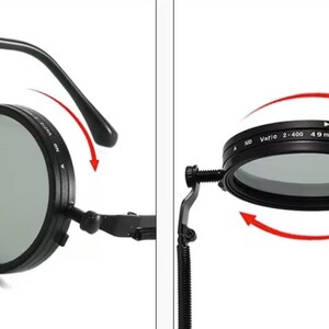 May include: Black circular camera lens filter with adjustable settings. The filter has a grey lens and is attached to a black frame with a rotating dial. The filter is labelled "ND Vario 2-400 49 mm MMX".