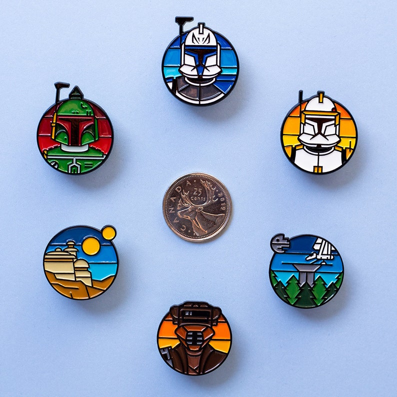 May include: Set of ten enamel pins featuring Star Wars characters and scenes. The pins are colorful and feature a variety of designs, including a character from the Clone Wars, a character from the original trilogy, and a scene from the Death Star.