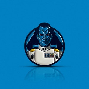 May include: A blue and white enamel pin featuring a character from Star Wars. The character is wearing a white uniform with a blue and yellow design. The pin is circular and has a black background.
