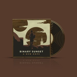 Op de afbeelding: Een vinyl platenhoes met een gouden rand. De hoes heeft een gestileerde illustratie van een persoon die naar een stad in de verte loopt. De albumtitel is "BINARY SUNSET A NEW HOPE".