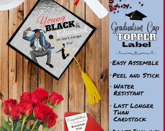 May include: Graduation cap topper label with the text "Young Black & Educated" and a cartoon illustration of a young Black man in a graduation cap and gown. The text "Oh Don't Forget Fly!" is also included. The label is silver with black glitter and has a yellow tassel.
