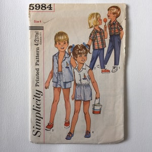 May include: Simplicity sewing pattern number 5984, size 4, for children's clothing. The pattern includes four different outfits: a sleeveless shirt and shorts, a short-sleeved shirt and shorts, a plaid shirt and trousers, and a striped shirt and trousers.
