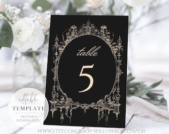 May include: Black and gold table number card with an ornate design and the text "table 5".