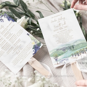 May include: Two wedding ceremony programs with a watercolor design of a vineyard. The program on the left has a list of the wedding party and the program on the right has the wedding ceremony details. The text on the program on the right reads "The Wedding of Amelia Hastings and Everett Wall August 27th, 2026 The Ceremony"
