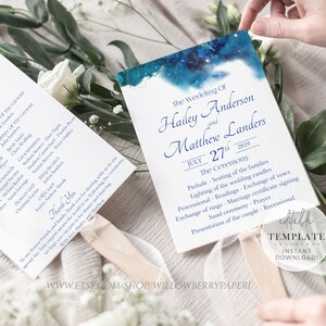 May include: Two wedding ceremony programmes with a blue watercolour background and stars. The programmes are printed with the names Hailey Anderson and Matthew Landers, the date July 27th, 2019, and the order of the ceremony. The programmes are folded in half and held together with a ribbon.