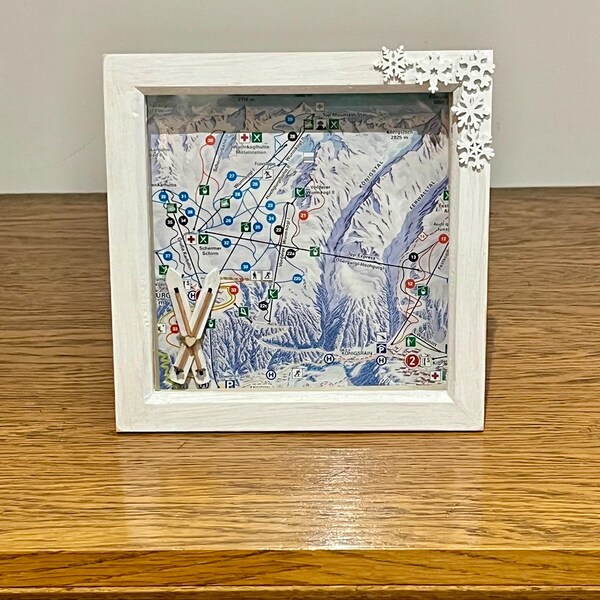 Photo frame ski themed made by me with miniature skis, snowflakes and piste map