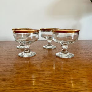 4 Vintage glass serving sundae dishes with  stunning gold rim