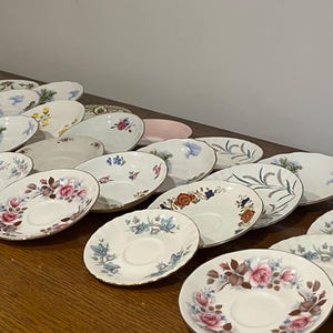 6 or 10 pretty Vintage china saucers
