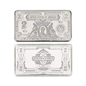 May include: Two silver bars with an ornate design. The bars feature the words "United States of America" and "Two" in the center. The bars are rectangular and have a raised edge.