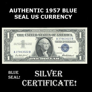 May include: A close-up of a one dollar bill from 1957 with a blue seal. The bill is a silver certificate and features a portrait of George Washington. The bill has the serial number A 37863022 B.