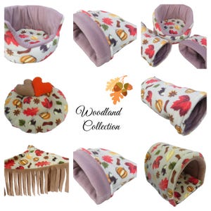 May include: A selection of pet beds and tunnels with a woodland theme. The items feature a cream fabric with autumn leaves, acorns, and pumpkin patterns. Some items have a lavender interior and trim. The text "Woodland Collection" is also visible.